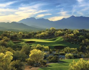 Beautiful golf course with mountains in the background.