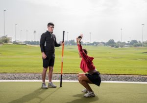 Tom working with a female golfer at CH3 Performance Academy