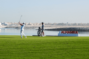 Two golfers on the course at Al Hamra Golf Club