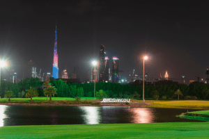 Floodlit golf course and views of the Burj Khalifa at night from The Track, Meydan Golf