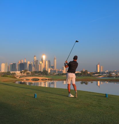 Golfer on the tee of the 18th at Montgomerie Golf Club Dubai