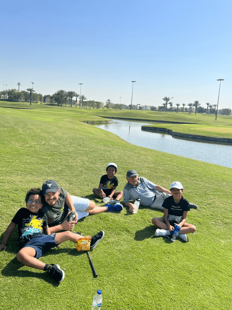Clintont Norris and family on the Par 3 Golf Course at Montgomerie Golf Club Dubai