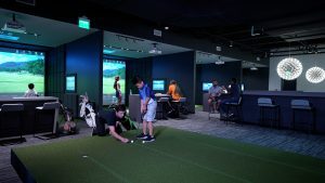 Golfinity: instructor working with junior golfer on putting