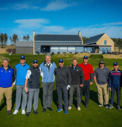 David Scott at Dumbarnie Links in front of the clubhouse with Soldiers from the Caddie program