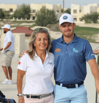 Sam Hobday with his mon at a driving range