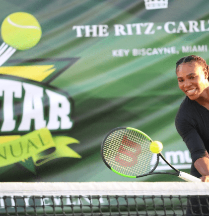 Venus Williams hitting a tennis ball over a net